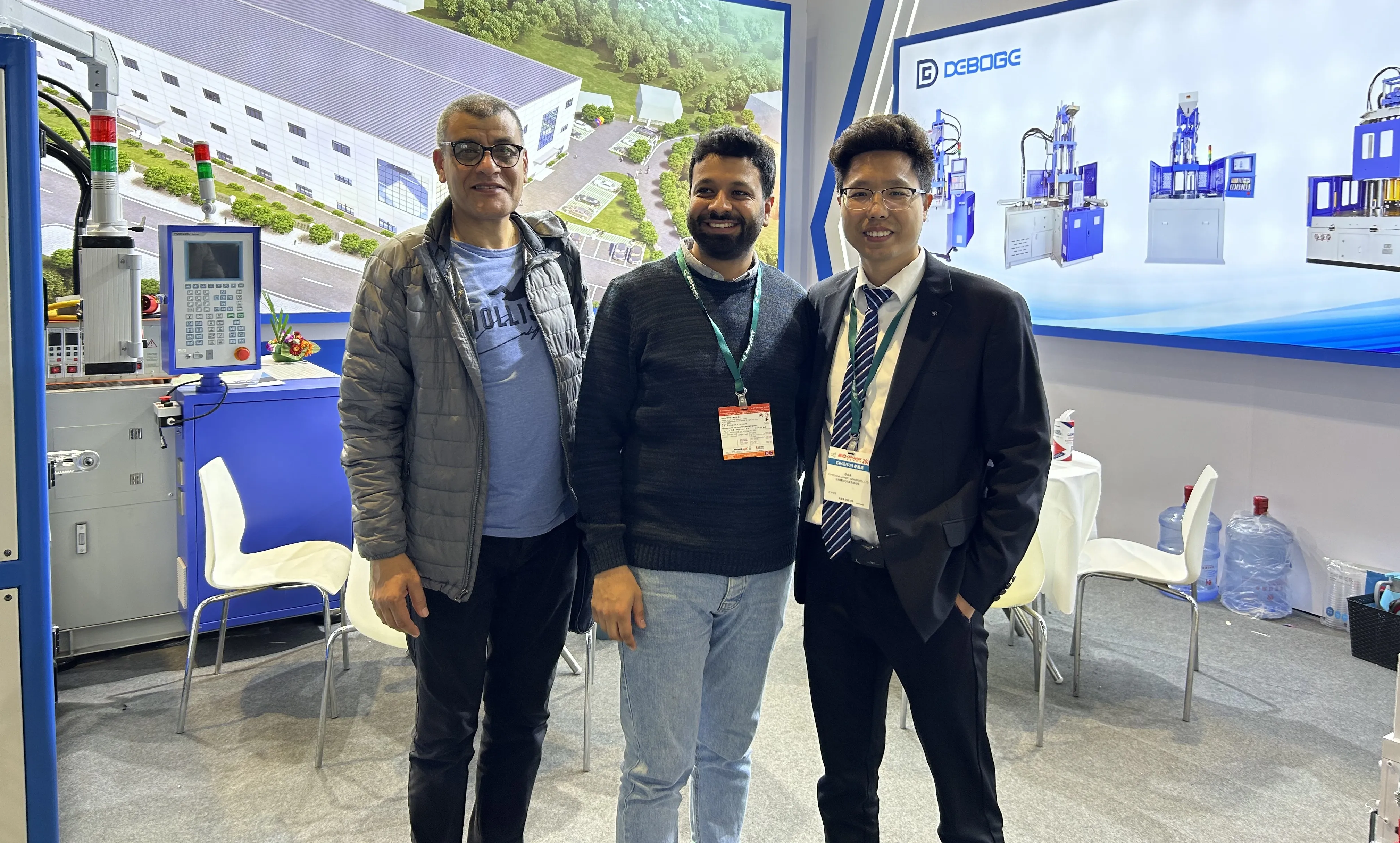 Deboge representative with international customer, handshake at the factory
