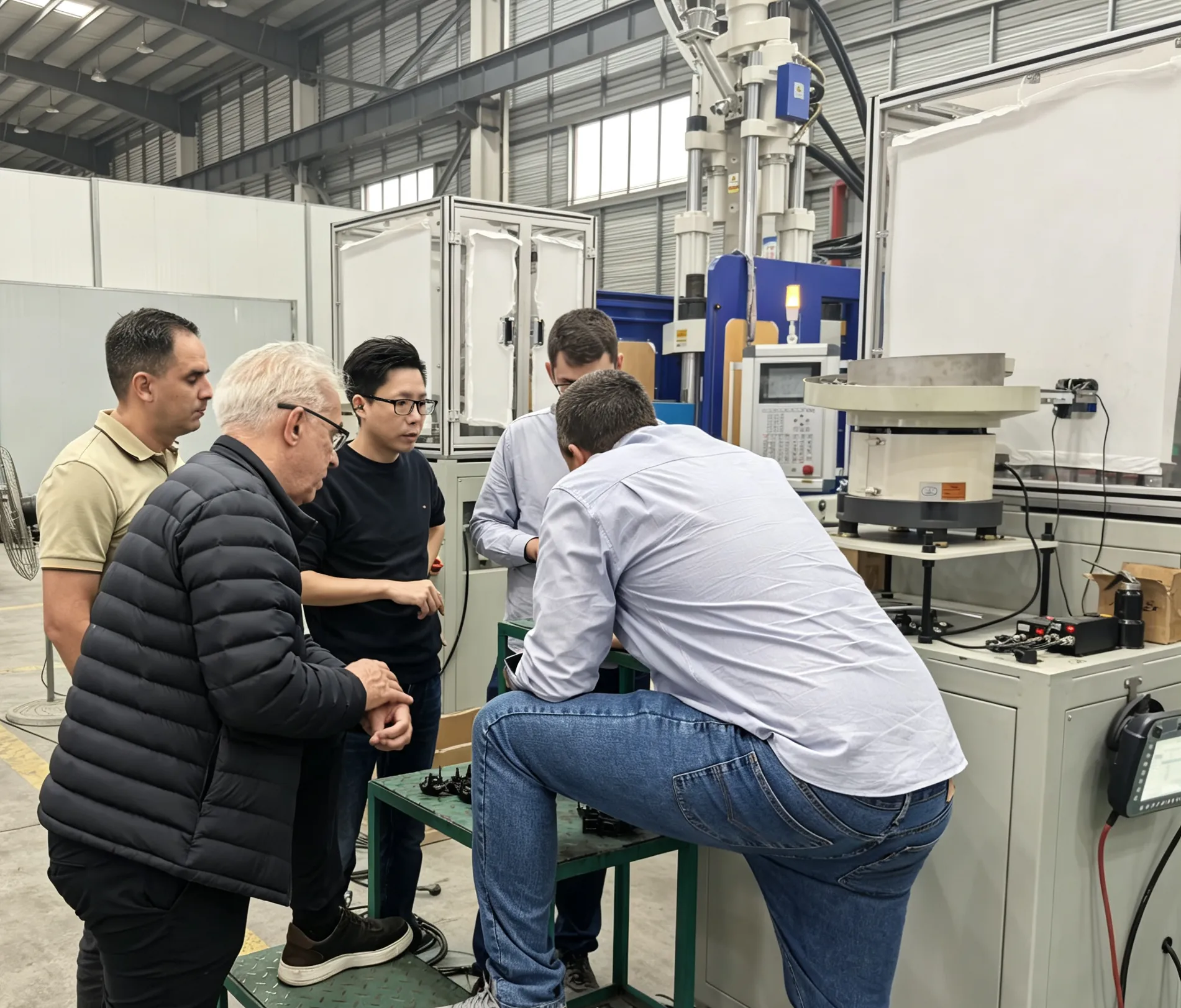 Deboge engineers and international customers in a meeting room discussing machine specifications