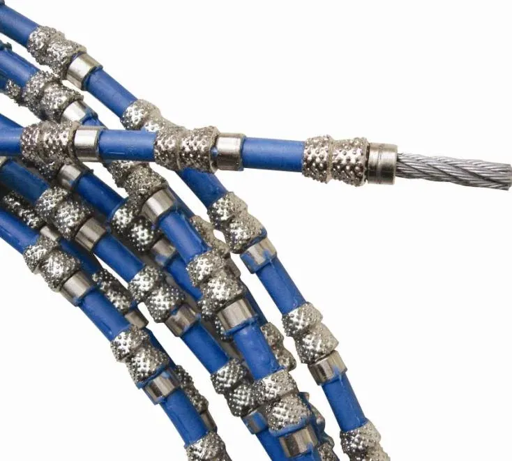 Diamond wire saw close-up showing blue coated sections between abrasive beads and exposed steel wire at one end