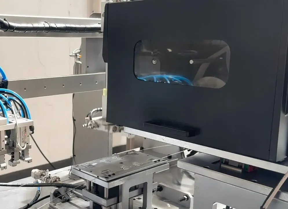 Enclosed processing station and adjacent handling equipment in the meter seal automation system