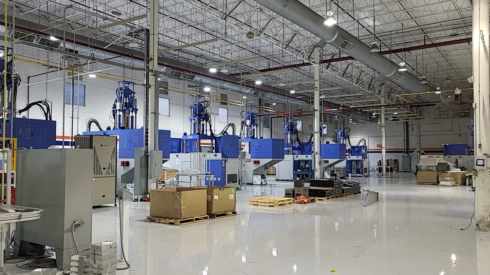 Deboge vertical injection molding machine installed and operating at a customer factory overseas