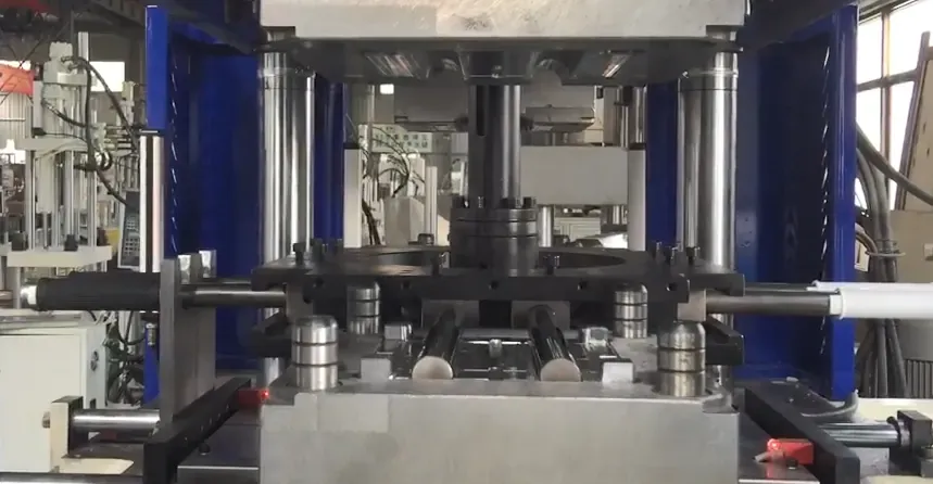 Front view of the handlebar grip mold and rotary core mechanism with a grip extending from the tooling