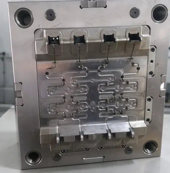 Seat back spring insert mold showing formed wire paths, locating features and plastic cavity areas