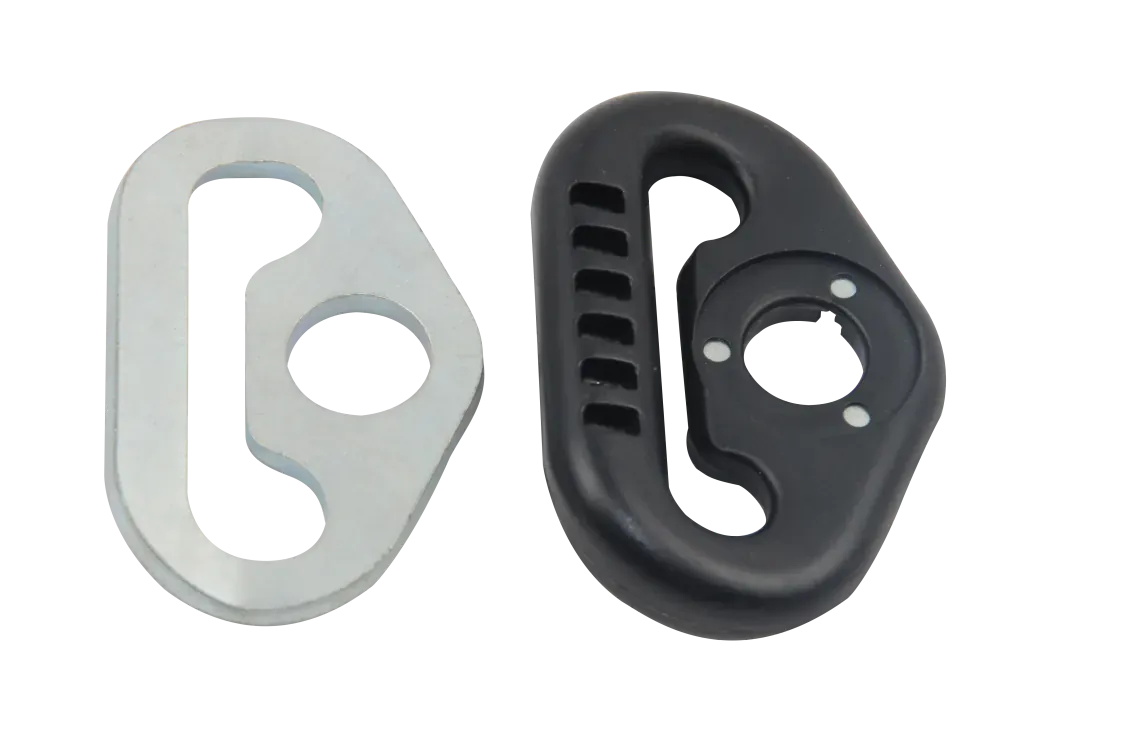 Metal seat belt D-ring insert beside the black plastic-overmolded guide ring, showing the circular opening and elongated slot