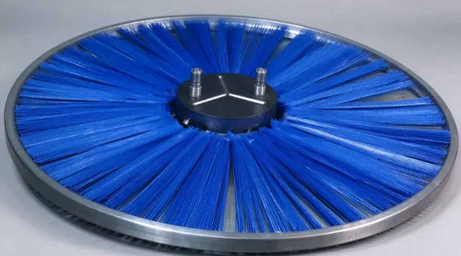 Blue circular snow sweeper wafer brush shown in the supplied tooling and fixture arrangement